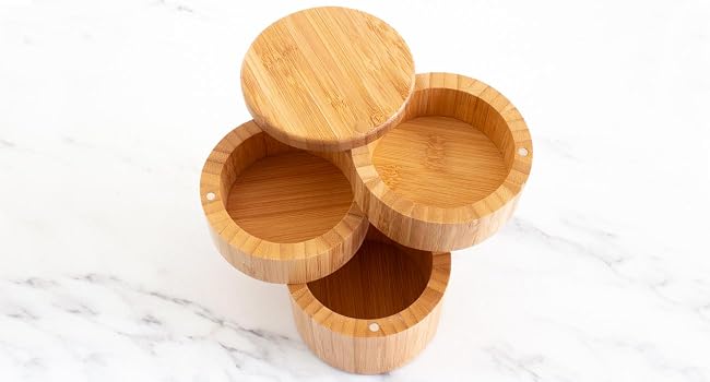 The Triple Bamboo Salt Box opened to show all three compartments on a marble kitchen countertop.