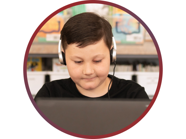 Headphones that improve focus. Young child studies on laptop with headsets on.