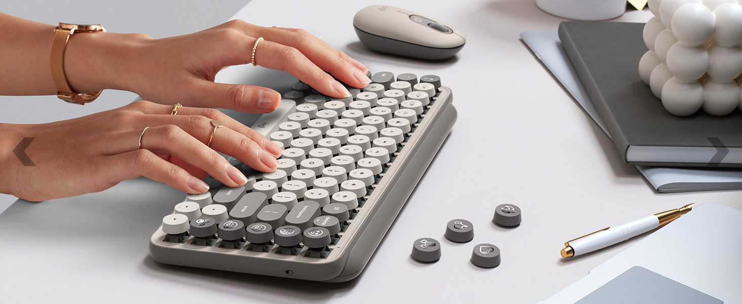 zoom of a woman typing on pop keys mist wireless mechanical beige gray keyboard