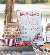 Table by a lake or ocean has lobster bake nautical or coastal kitchen items spread out