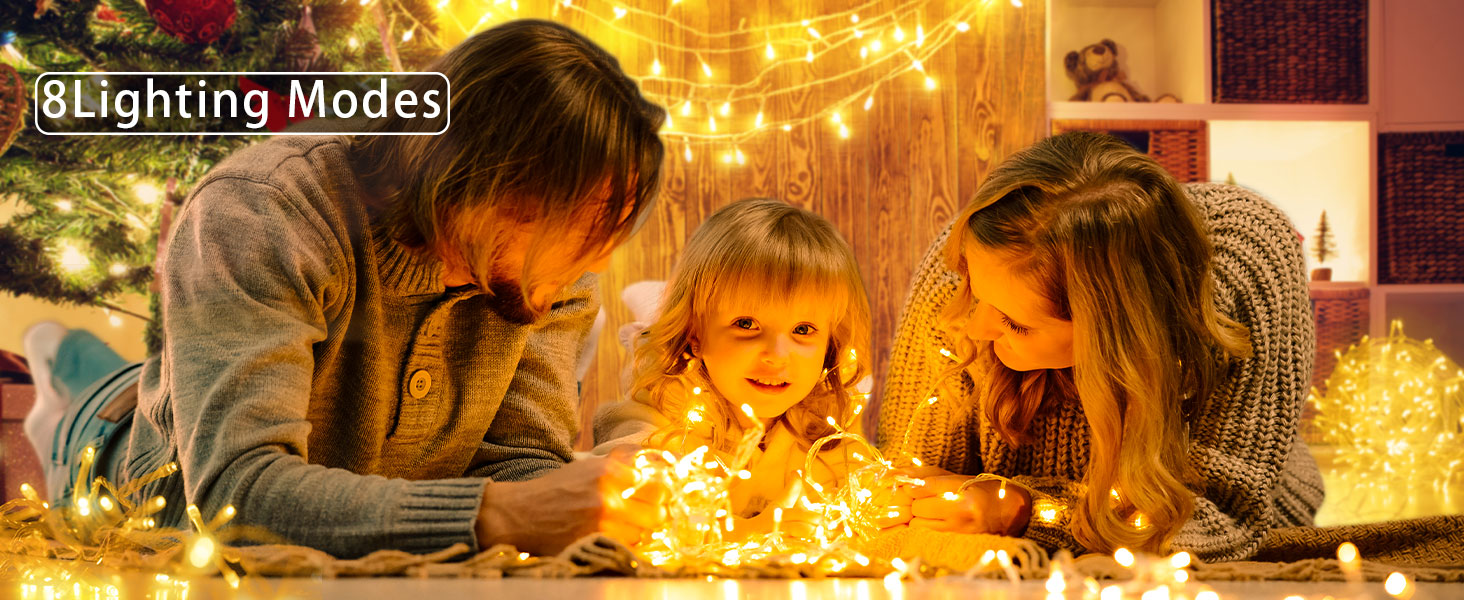 a family of three playing with christmas lights