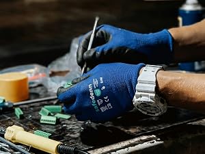 Blue Safedenn work gloves for precision soldering and electronic repair in a workshop setting.
