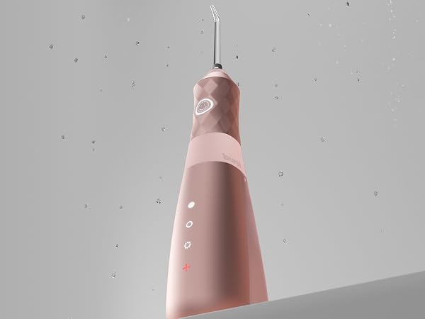 pink water flosser with water drops