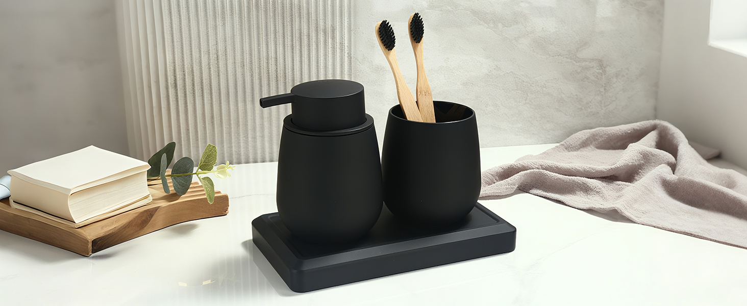 Two black decorative rabbit or bunny figurines displayed on a stand, with books and indoor plants in the background on a light surface.