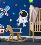 Children's bedroom or playroom interior scene showing furniture and decorative elements with star patterns on dark blue wall.