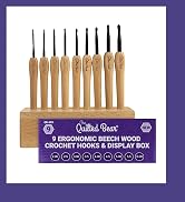 Text reads 'Quilted Bear' 'CROCHET HOOKS & DISPLAY BOX' '9 ERGONOMIC BEECH WOOD'. Set of nine wooden crochet hooks displayed in ascending size order on wooden stand.