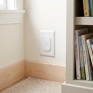 covered wall outlet next to a bookshelf
