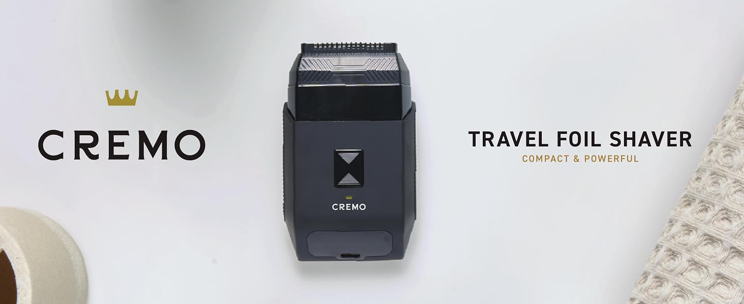 Cremo Travel Foil Shaver displayed with brand logo and grooming accessories