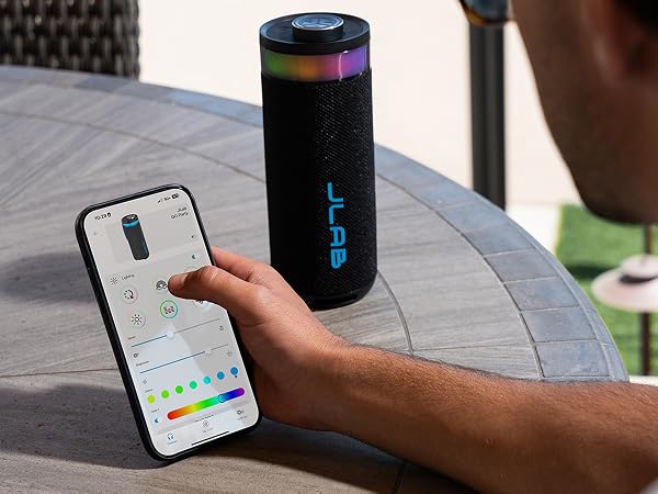 A person using the JLab app to adjust the RGB party light settings