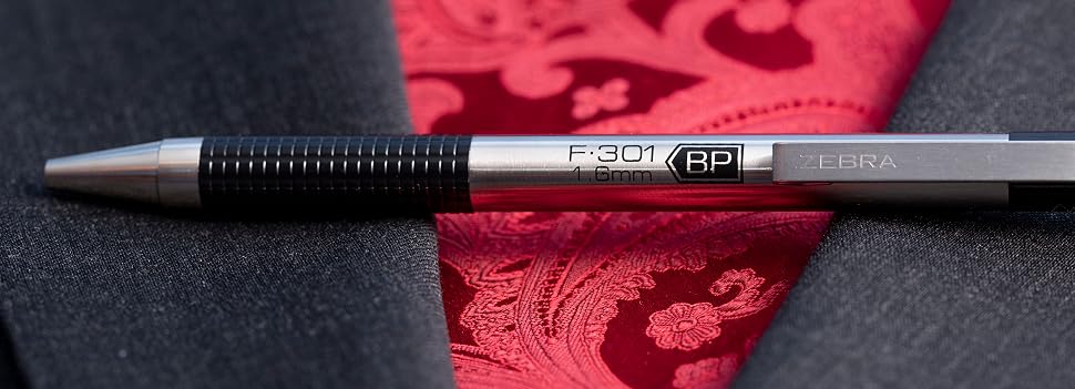 zebra pen f-301 retractable ballpoint pen closeup next to suit and tie, executive style
