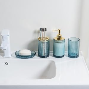 4 piece bathroom accessories set with transparent blue glass finish and brass accents