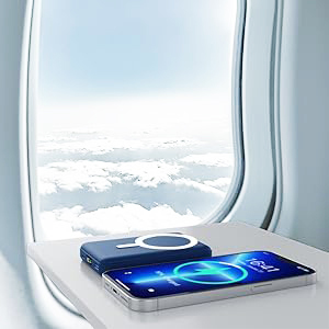 Blue smartphone with water droplets on screen positioned against airplane window with clouds visible outside during flight.