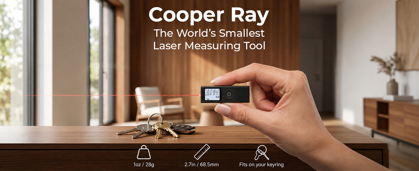Hand holding the tiny Cooper Ray laser measurement tool, red beam crossing a modern room