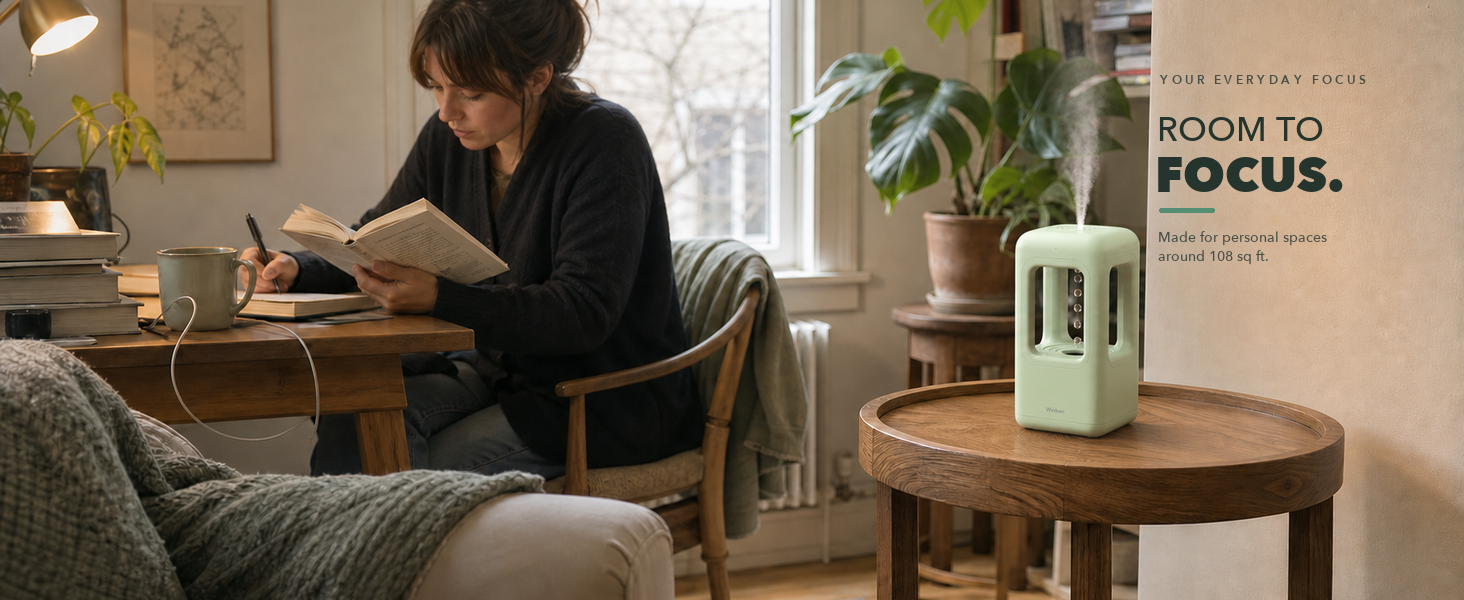 green personal-space humidifier near indoor plants on a protected surface