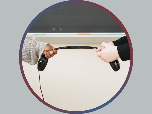 Two children attempting to pull apart a Cyber Acoustics headphones