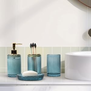 4 piece bathroom accessories set with transparent blue glass finish and brass accents