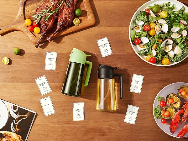 Overhead view of a wooden table with prepared meals, including roasted meat, salad, and seafood. Two glass containers with colored lids are surrounded by small white cards.