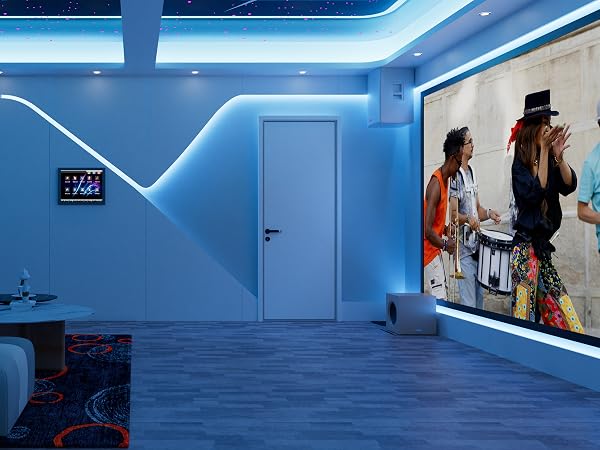 Modern room with blue LED lighting, wood-look flooring, and a large wall-mounted display showing a vibrant image. Small digital panel on left wall.