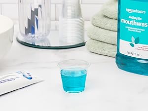 Mouthwash in a clear small plastic cup.