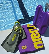 closeup of arena training swim fins kickboard and pull kick by the pool bold purple