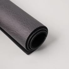 Rolled black PU leather coffee mat showing flexible, cushioned, non-slip design.