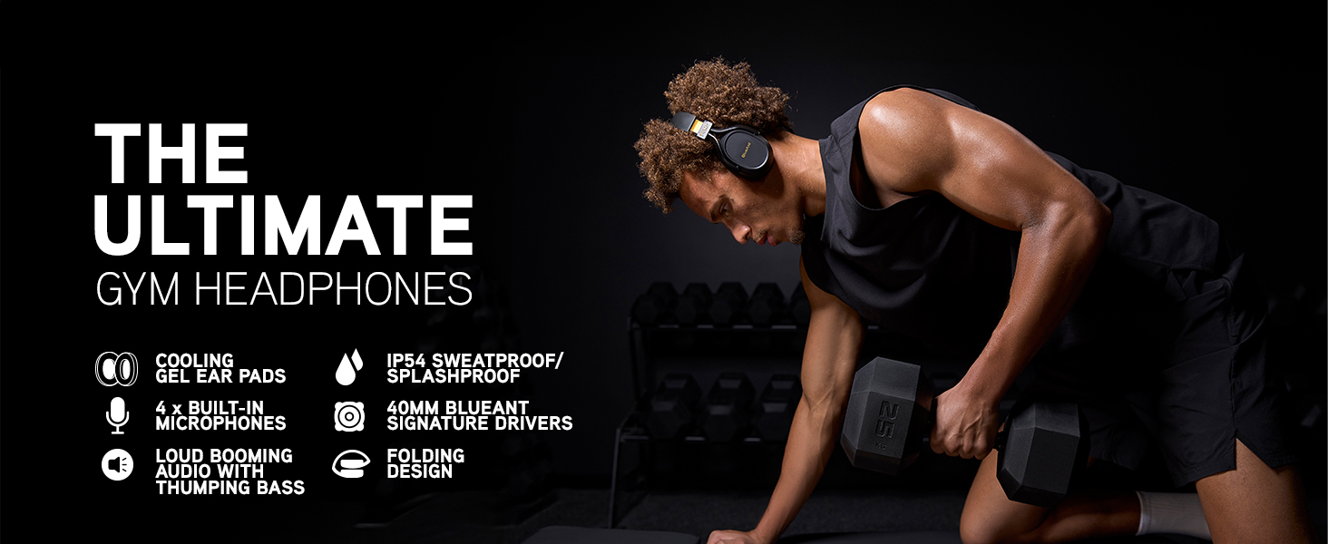 Dyson trains in the gym wearing Pump X headphones, lifting dumbbells with focus and determination.