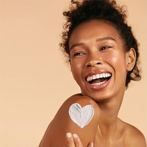 Woman with a heart swatch of lotion on her shoulder
