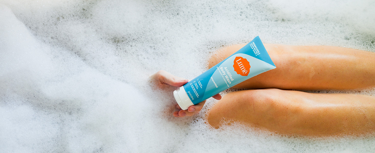 Lume Acidified Body Wash in Unscented being used in a bath tub