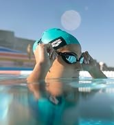female athlete wearing an arena swim cap and arena swim goggles in the pool during the summer