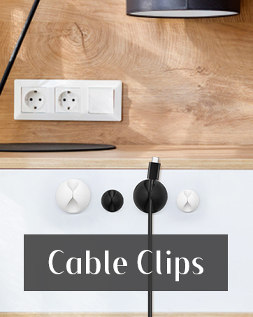 Cable management clips in white and black, shown adhered to a wooden surface. Two electrical outlets visible above. Text overlay reads 'Cable Clips'.