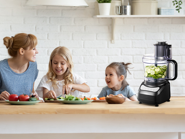 a woman and two children in a kitchen preparing food.