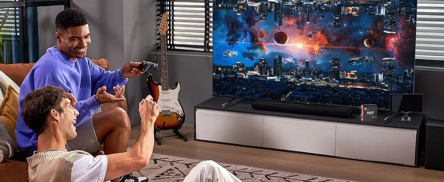 Two people play a space-themed Switch game in TV mode, with the 2-in-1 Switch Dock Capture Card