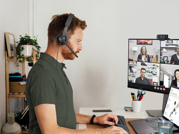 a man having a video call using zone 750 wired on-ear headset with noise-cancelling microphone