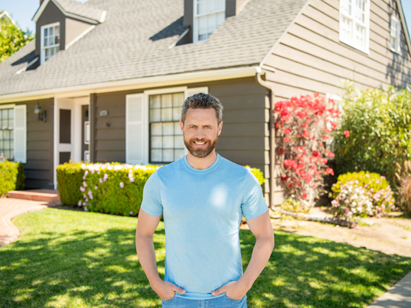 a man standing in front of a house