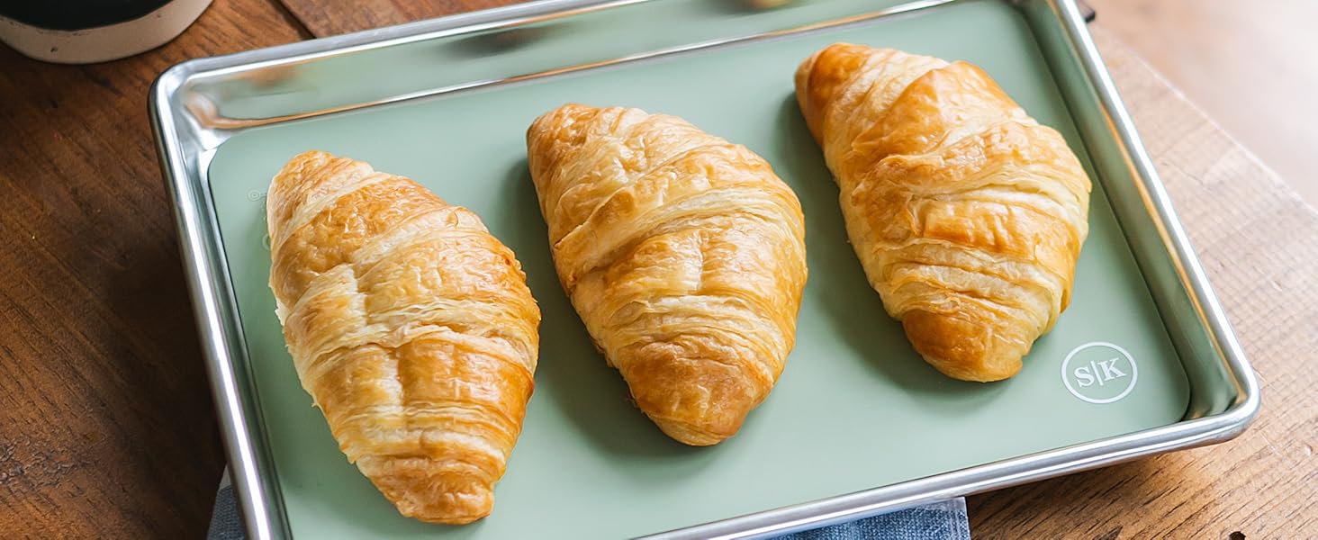 Sage green silicone baking sheet in quarter sheet size with croissants