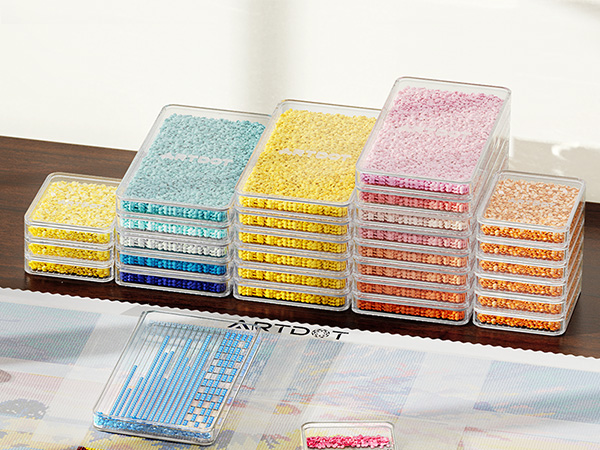 Collection of transparent storage containers arranged in rows, filled with colorful items in blue, yellow, pink, and orange.