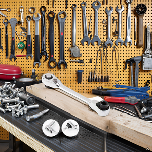 A workbench with various tools and components neatly organized around the product.