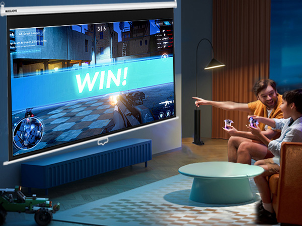 Large projector screen displaying a video game with 'WIN!' message. Two people on a couch playing with handheld controllers in a dimly lit living room setting.