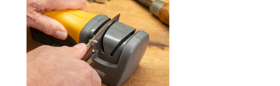 handheld electric knife sharpening being used to sharpen straight edge blades pocket hunting knife