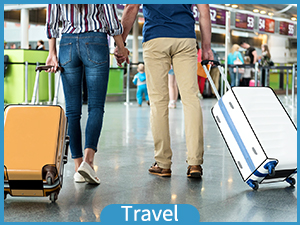 a couple walking with luggage at the airport.
