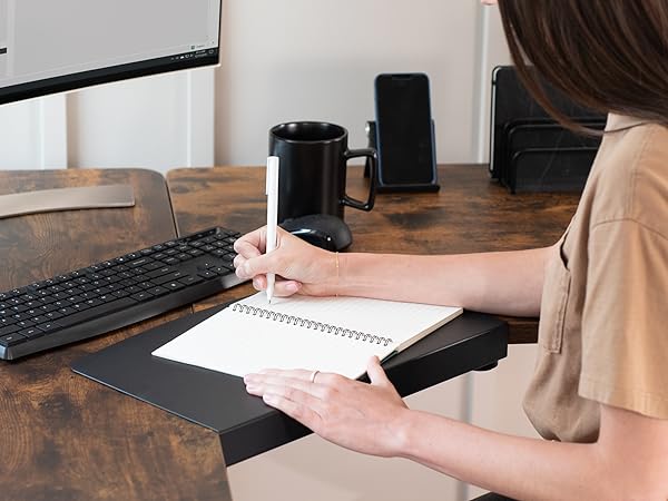 Woman writing on desktop surface