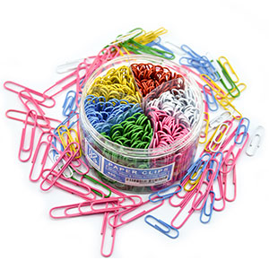 Color paper clips box. Paper clips scattered around the box to show the variety of clips