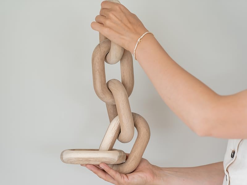 A pair of hands holding acacia wood chain