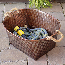 HydroTech hose being stored in a planter on a patio