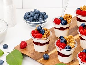Mini parafaits in small plastic clear cups.