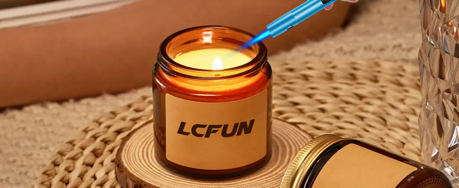Amber glass jar candle labeled 'LCFUN' on wooden coaster. Blue wick trimmer visible, candle lit with warm glow.