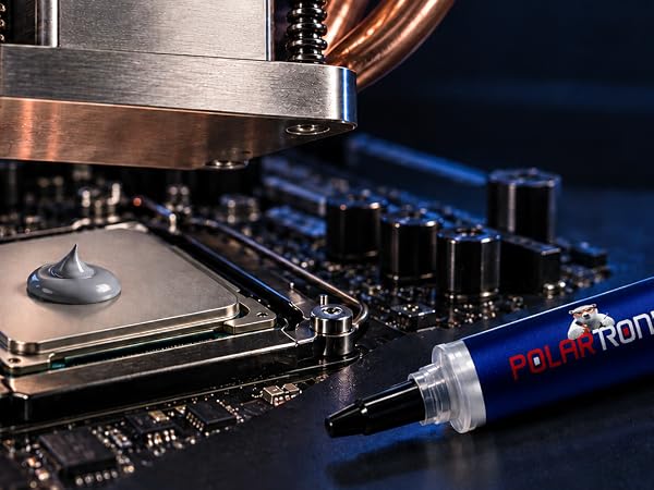 thermal paste syringe on surface in front ofcpu with thermal paste on it