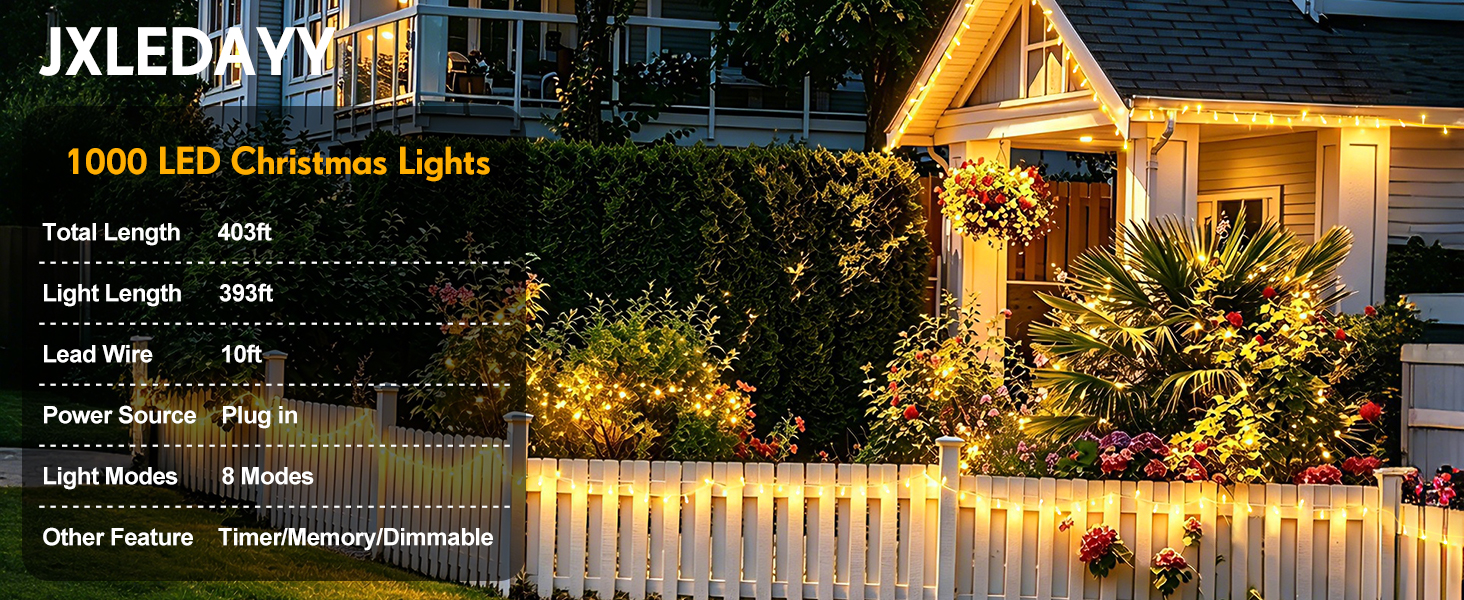 Text reads "JXLEDAY", "1000 LED Christmas Lights", "Total Length: 40m", "Light Length: 25m", "Tail Wire: 3m", "Power Source: Plug in", "Light Color: Warm White", "Waterproof Rating: IP44", "Other Features: Timer/Memory/Dimmable". String of warm white LED Christmas lights draped on residential house exterior with holiday ambiance.