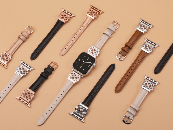 Collection of smartwatch bands in various colors and patterns, including leather and fabric straps with metal clasps. Some bands attached to watch faces.