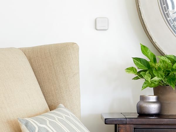 Smart Sensor on wall of living room next to mirror.